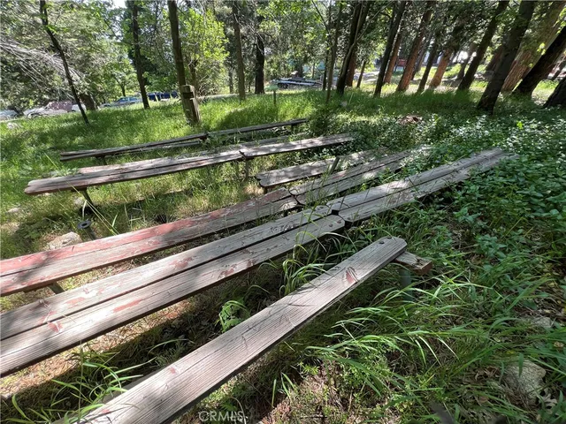 a view of a yard with wooden fence