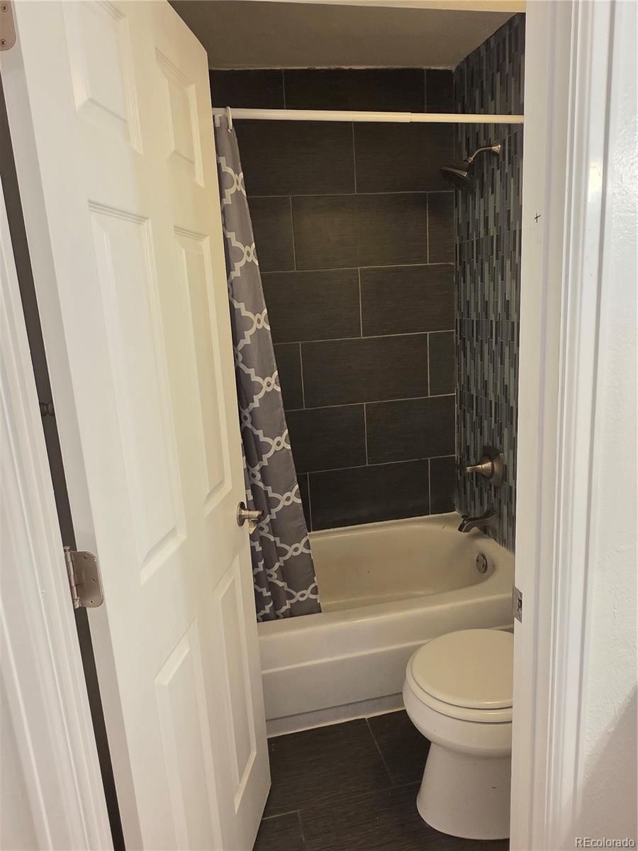 2 Adams Street, Unit 608 Denver, CO 80206 - Photo 11 of 18 a bathroom with a toilet and a bathtub