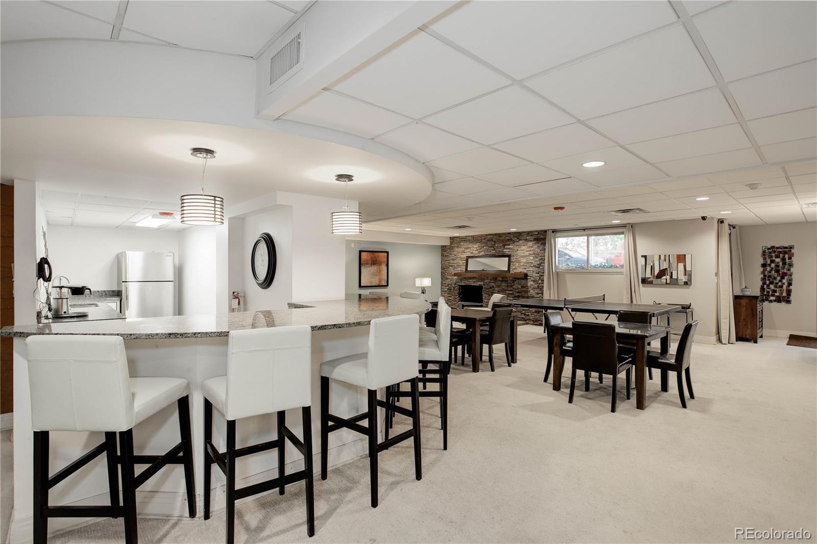 2 Adams Street, Unit 608 Denver, CO 80206 - Photo 14 of 18 a kitchen with a dining table chairs and white cabinets