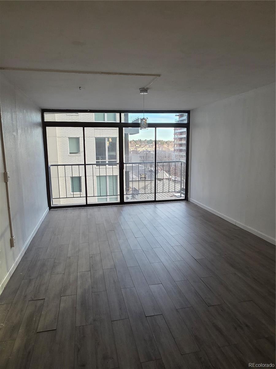 2 Adams Street, Unit 608 Denver, CO 80206 - Photo 7 of 18 wooden floor in an empty room with a window