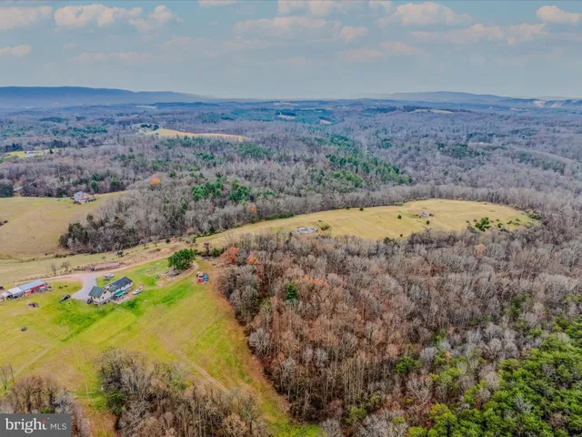 a view of a lake with beach and mountain in the back