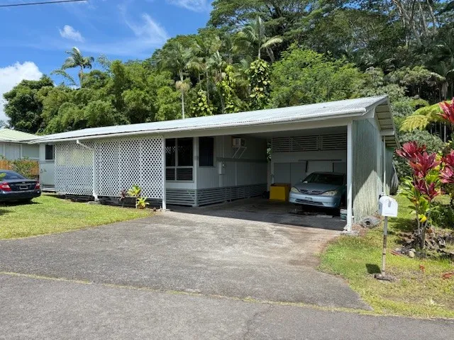 a view of a car parked in front of a house