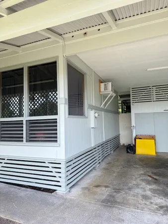 a view of a porch with a table and chairs
