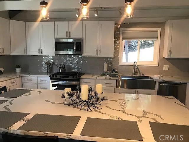 42983 Fern Avenue Big Bear Lake, CA 92315 - Photo 3 of 9 a kitchen with a sink a stove and cabinets