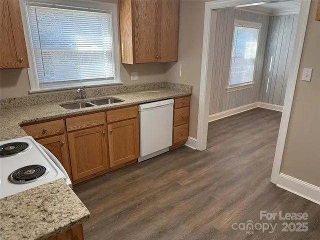a kitchen with a sink a stove and cabinets