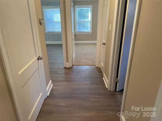 a view of a hallway with wooden floor