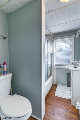 a bathroom with a white toilet sitting next to a window