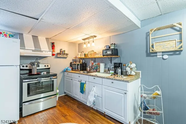 a kitchen with a stove and white cabinets