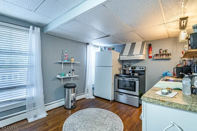 a kitchen with refrigerator and cabinets