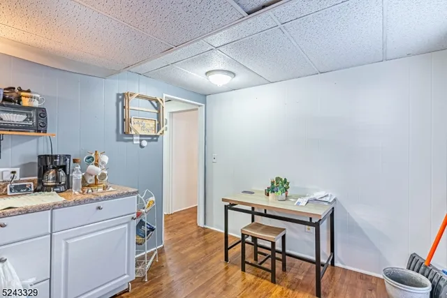 a view of a workspace with furniture and wooden floor
