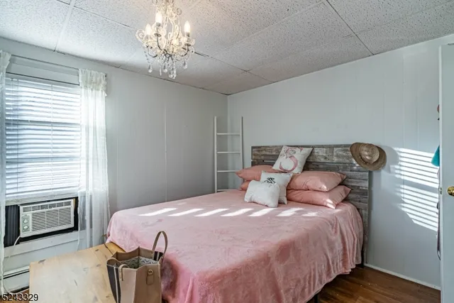 a bedroom with a bed and a chandelier