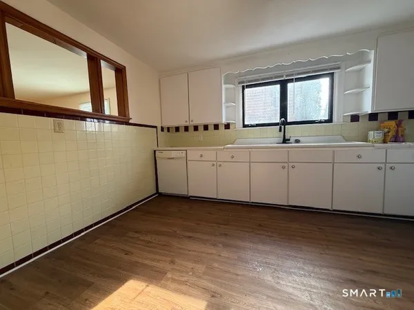 a spacious bathroom with a vanity and a window