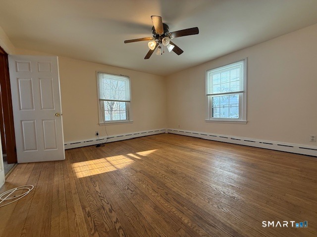 34 New Haven Avenue Waterbury, CT 06708 - Photo 5 of 14 an empty room with wooden floor and windows