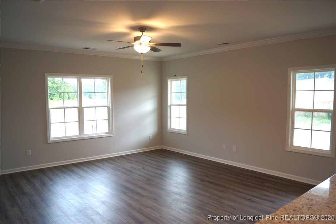 174 Nectar Lane Bunnlevel, NC 28323 - Photo 20 of 41 a view of an empty room with wooden floor and a window