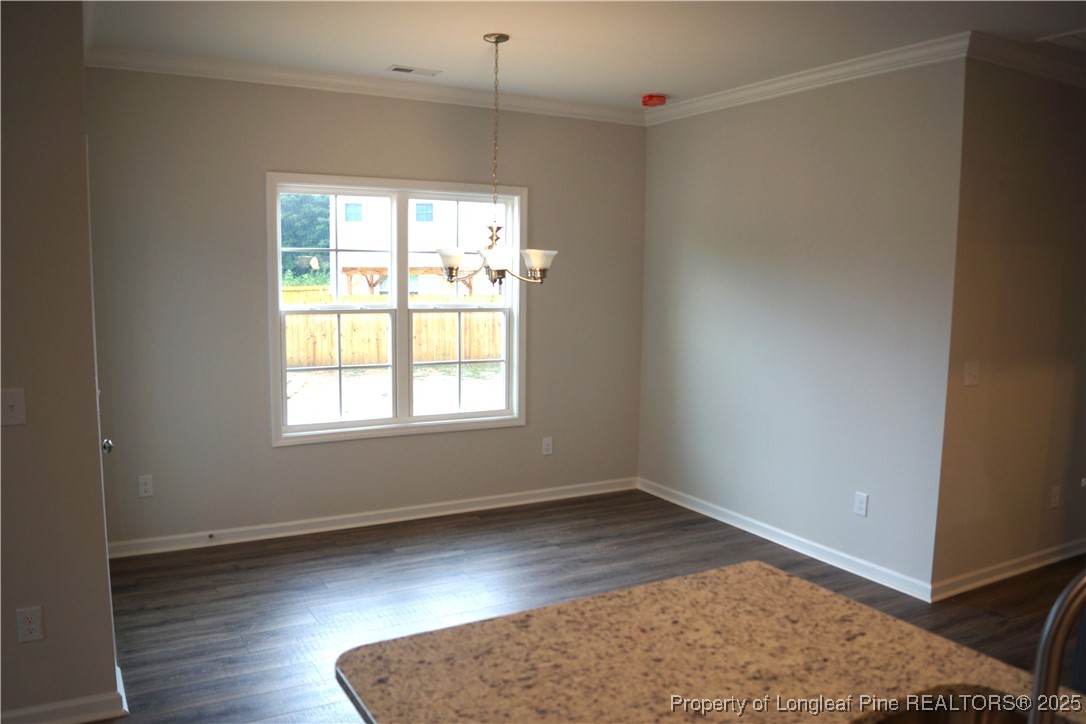 174 Nectar Lane Bunnlevel, NC 28323 - Photo 21 of 41 an empty room with wooden floor and windows