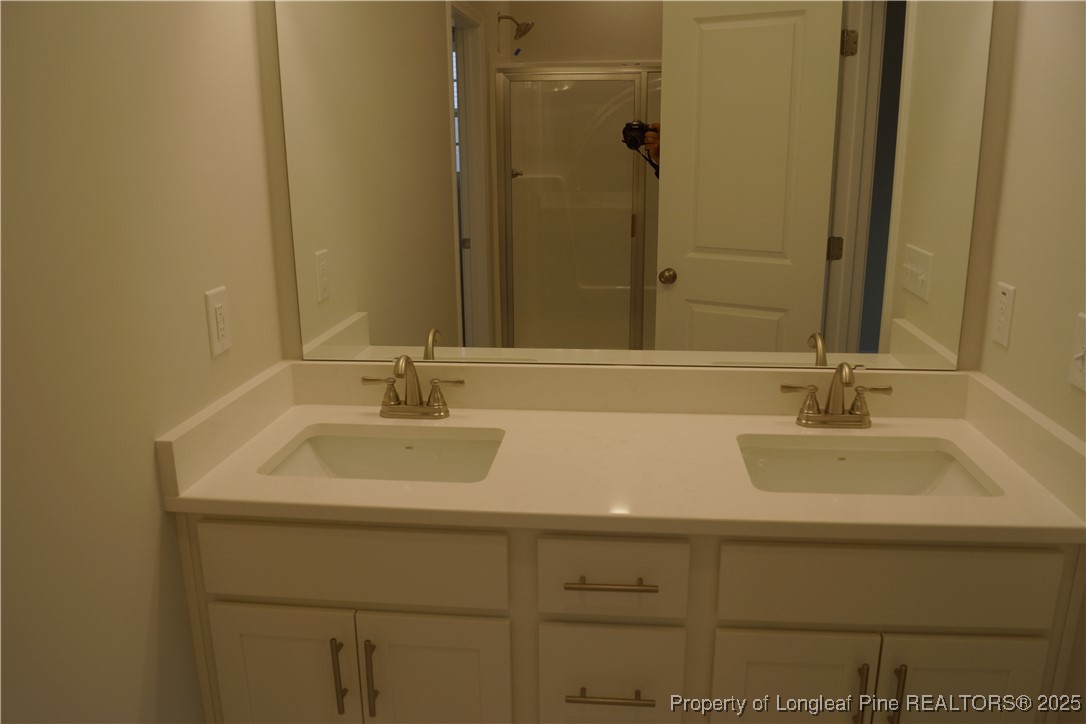 174 Nectar Lane Bunnlevel, NC 28323 - Photo 24 of 41 a bathroom with a sink and a mirror