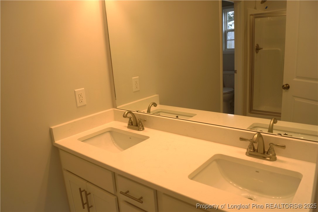 174 Nectar Lane Bunnlevel, NC 28323 - Photo 26 of 41 a bathroom with a sink and a mirror