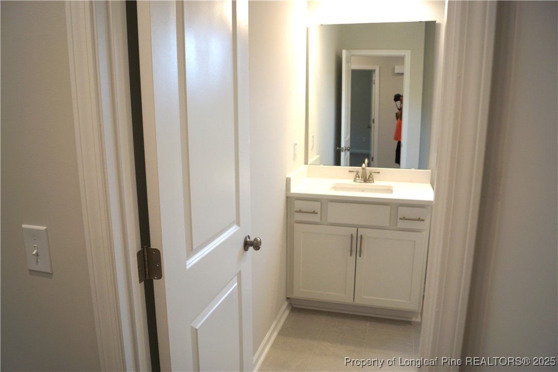 174 Nectar Lane Bunnlevel, NC 28323 - Photo 30 of 41 a bathroom with a sink a toilet and a mirror