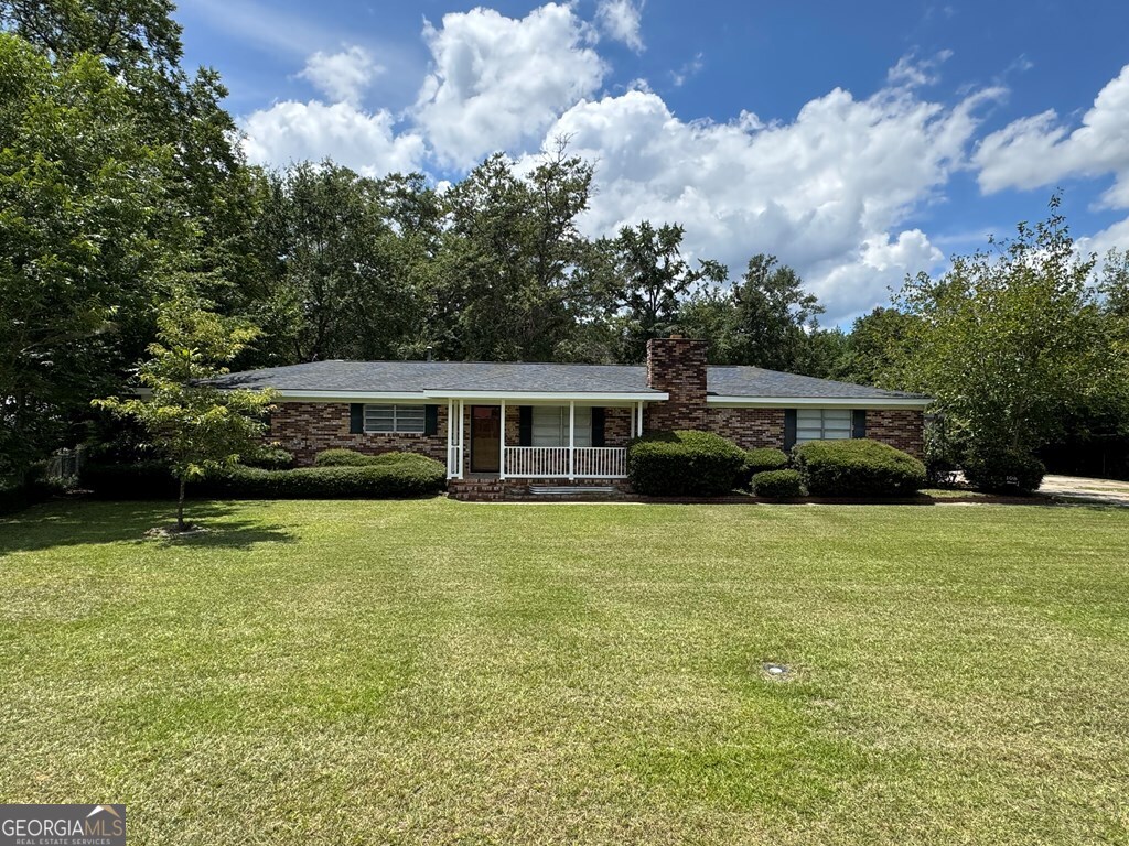 108 Plum Street Dublin, GA 31021 - Photo 2 of 33 a front view of a house with a garden