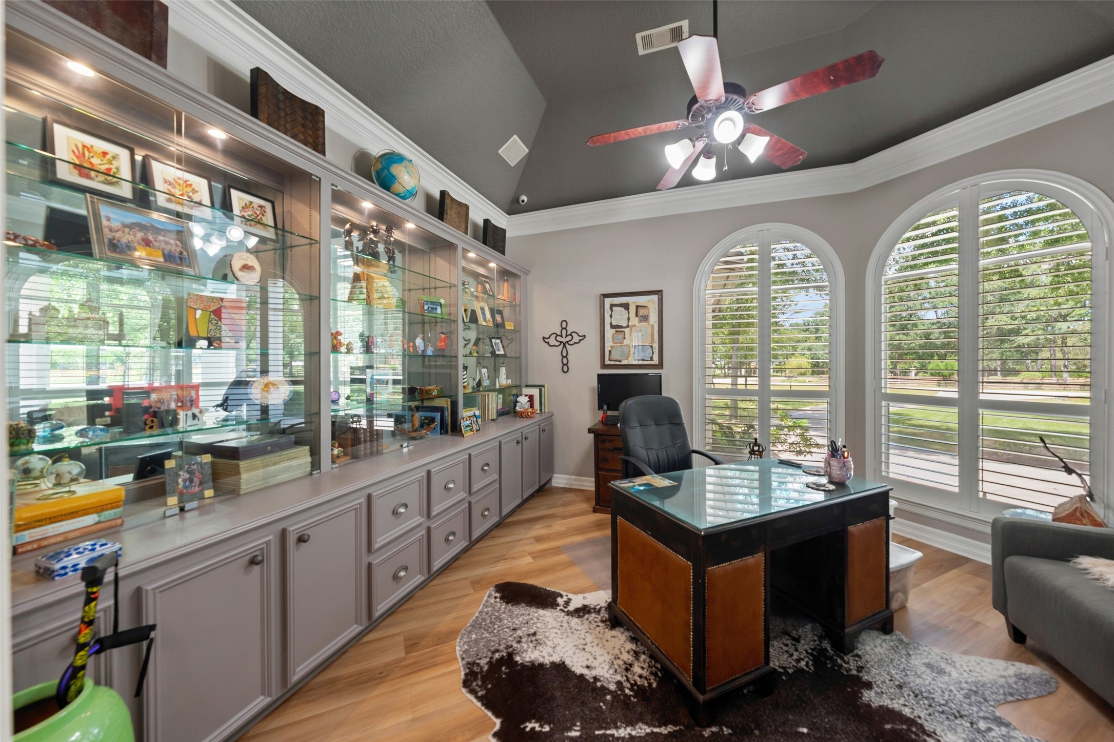 38053 Windy Ridge Trail Magnolia, TX 77355 - Photo 21 of 50 Built-in wall to wall lighted display cabinets with glass, built in file drawers and arch windows with custom plantation shutters & gabled ceiling.