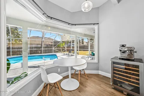 a kitchen with stainless steel appliances granite countertop a stove top oven a sink dishwasher and white cabinets with wooden floor