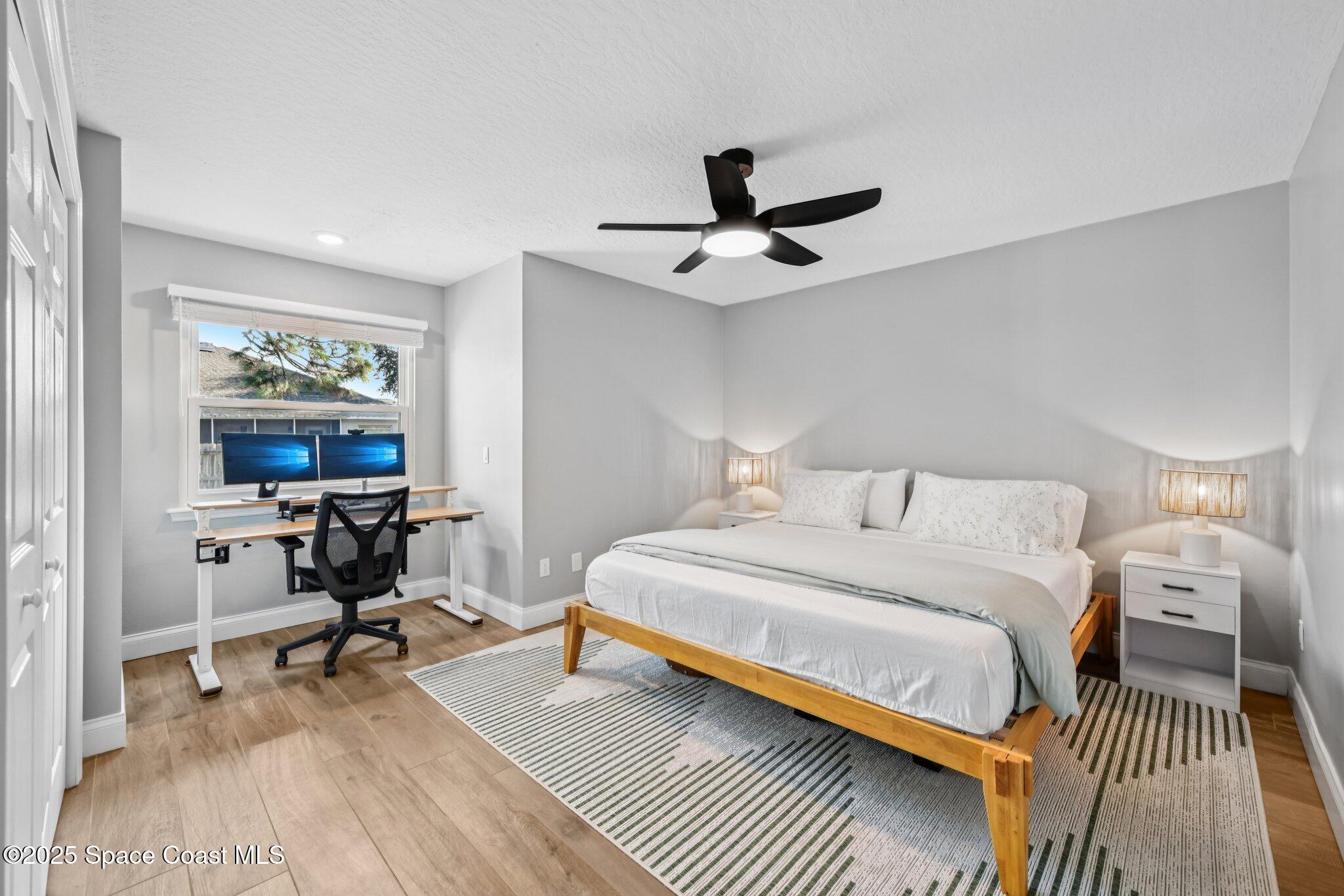 1935 Gates Road Merritt Island, FL 32952 - Photo 21 of 54 a bedroom with a bed a table and a chandelier