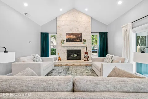 a living room with furniture and kitchen view