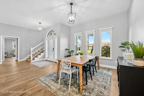 a view of a dining room with furniture and wooden floor