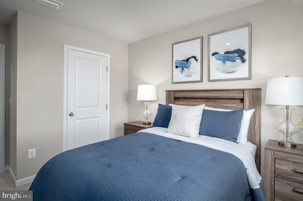 a bedroom with a bed and lamp on table