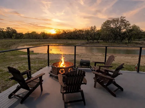 a view of a ocean with couple of chairs