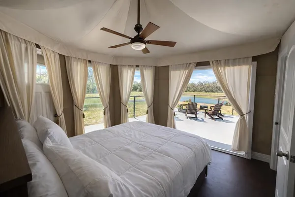 a bedroom with a large bed and a large window