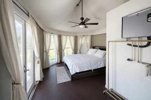 a bedroom with a bed dresser and a window