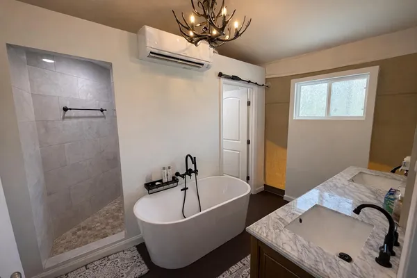 a bathroom with a tub and a sink