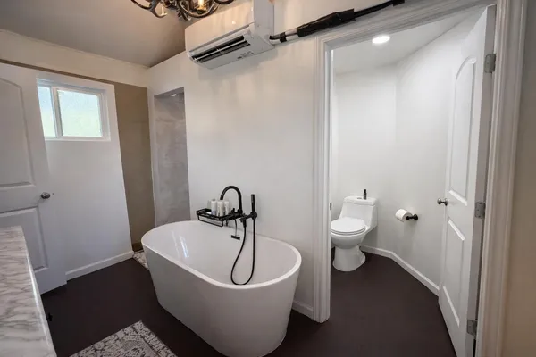 a white bath tub sitting next to a white toilet