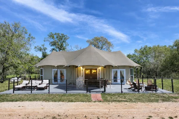 a house with lots of trees in the background