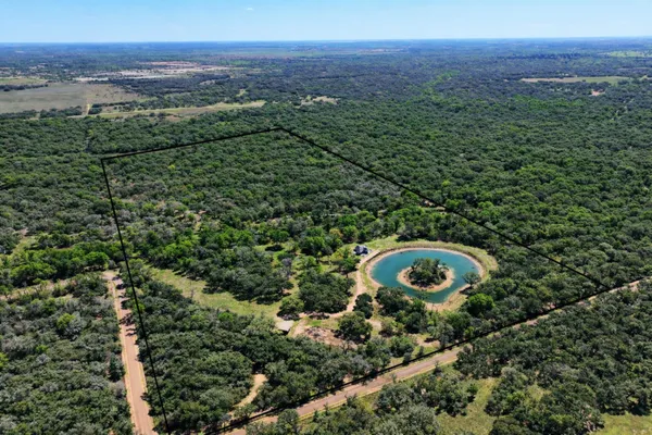an aerial view of a forest with houses