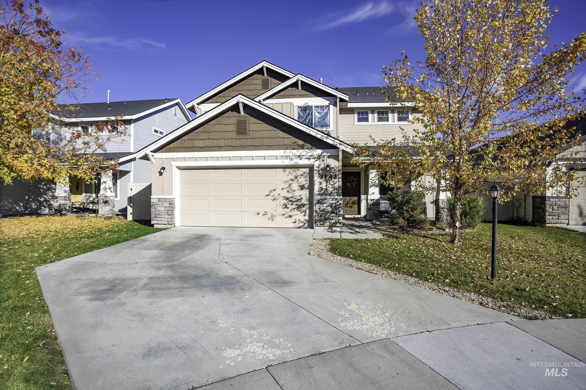 3142 North Sharon Avenue Meridian, ID 83646 - Photo 1 of 1 Craftsman inspired home with a front yard, stone siding, driveway, and a garage