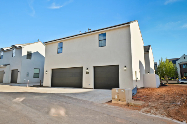 4346 Canterbury Road Hurricane, UT 84737 - Photo 3 of 37 Back of house with an attached garage, concrete driveway, and stucco siding
