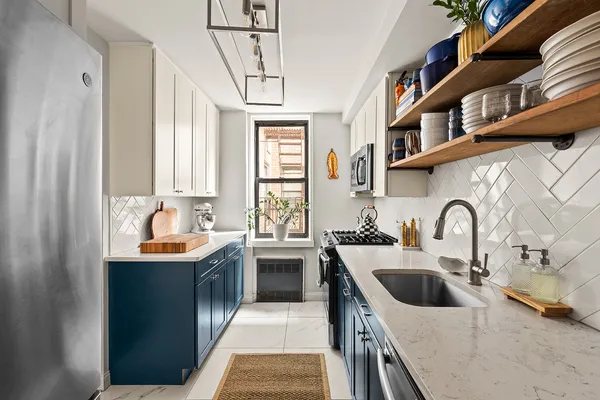 a kitchen with stainless steel appliances granite countertop a sink and cabinets