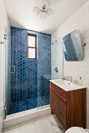 a bathroom with a sink a mirror and shower
