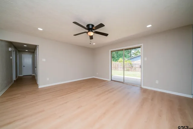 a view of a livingroom with a ceiling fan and window