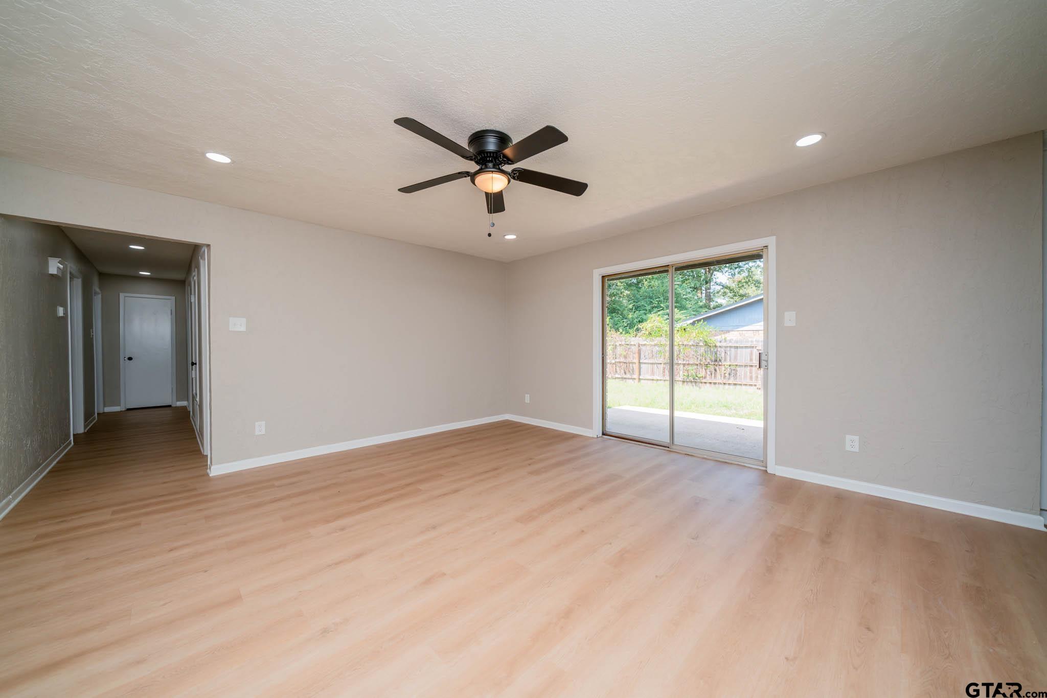 1411 Sapphire Street Longview, TX 75602 - Photo 13 of 38 a view of a livingroom with a ceiling fan and window