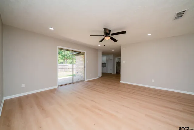 a view of a livingroom with a ceiling fan and window