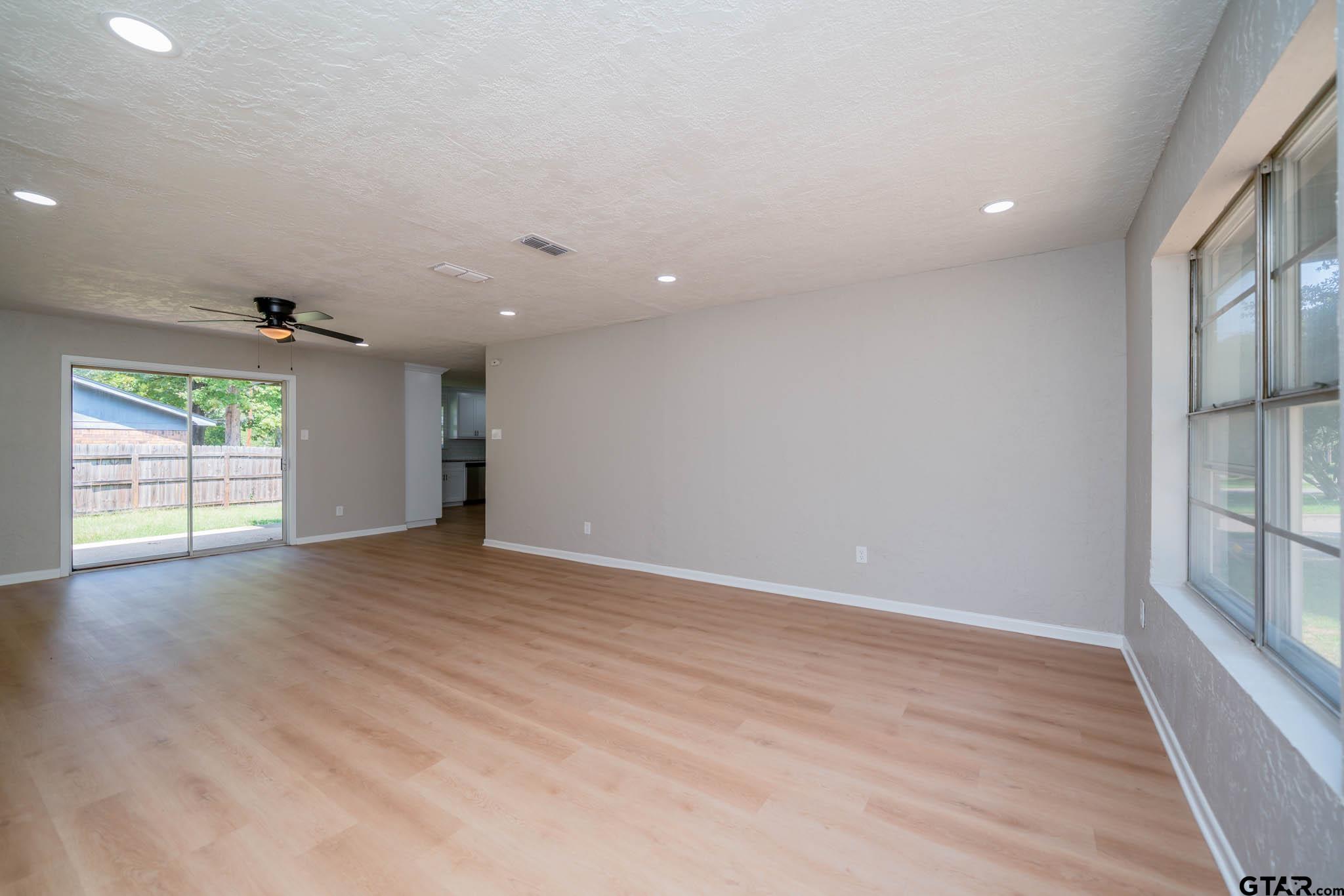 1411 Sapphire Street Longview, TX 75602 - Photo 15 of 38 an empty room with wooden floor and windows