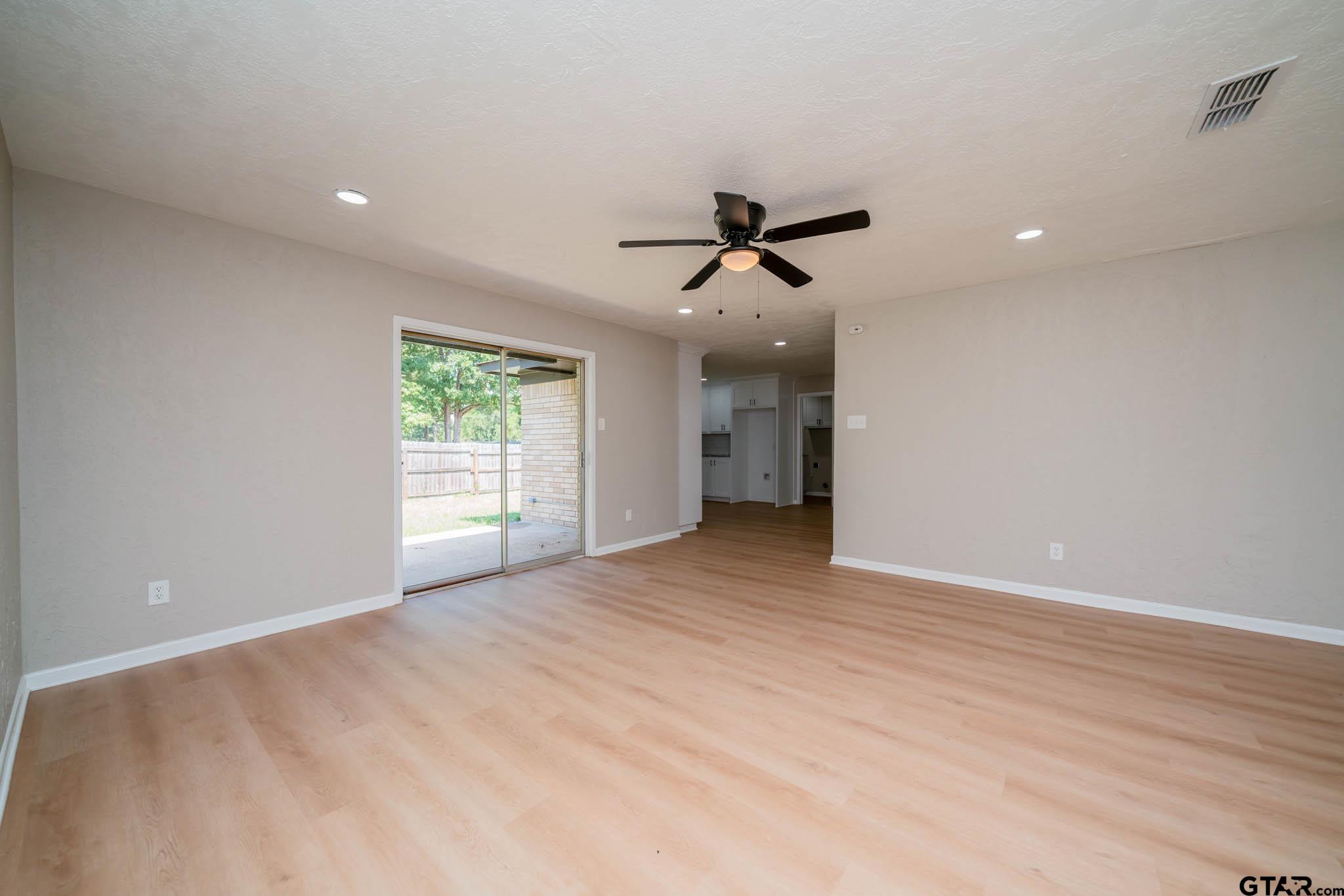 1411 Sapphire Street Longview, TX 75602 - Photo 16 of 38 a view of empty room with wooden floor and fan