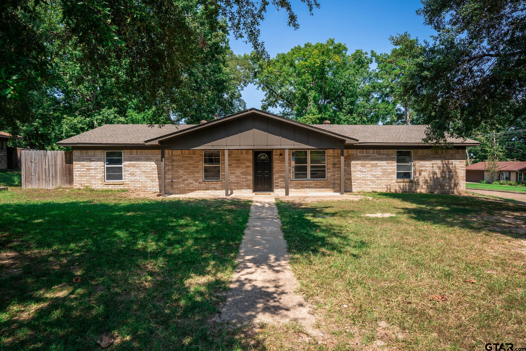 1411 Sapphire Street Longview, TX 75602 - Photo 3 of 38 a front view of a house with garden