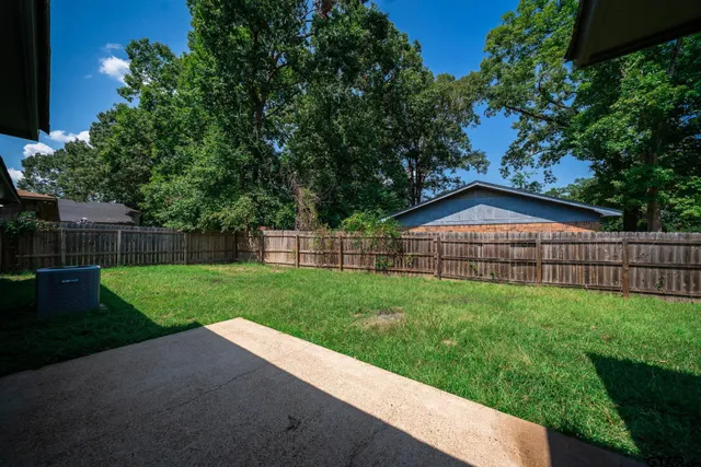 a view of an house with backyard space and garden