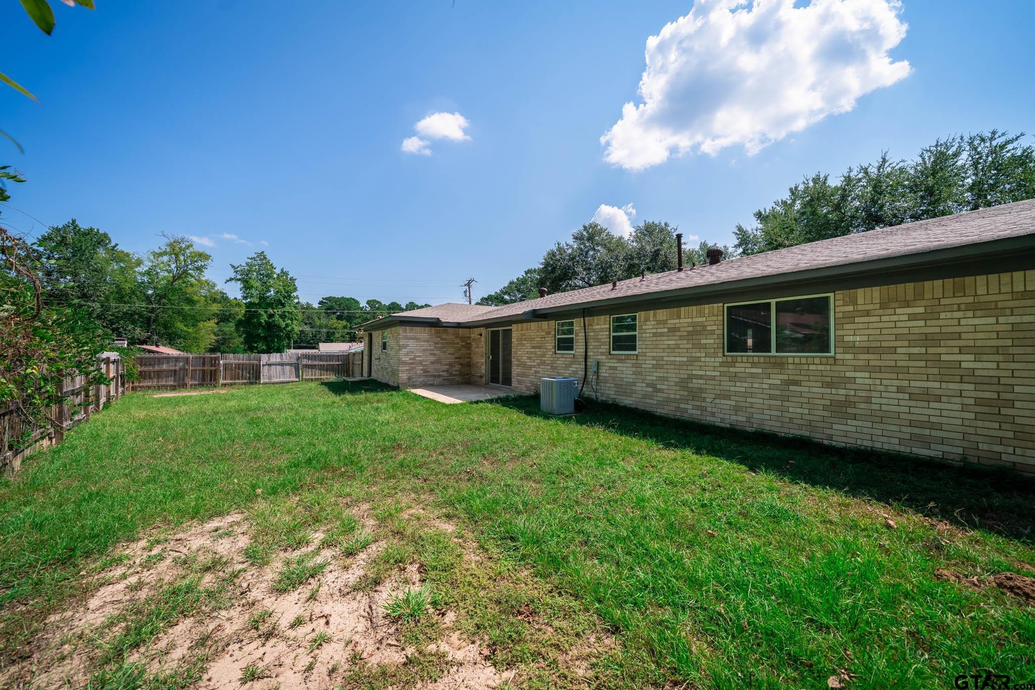 1411 Sapphire Street Longview, TX 75602 - Photo 36 of 38 a view of a backyard with plants and a backyard