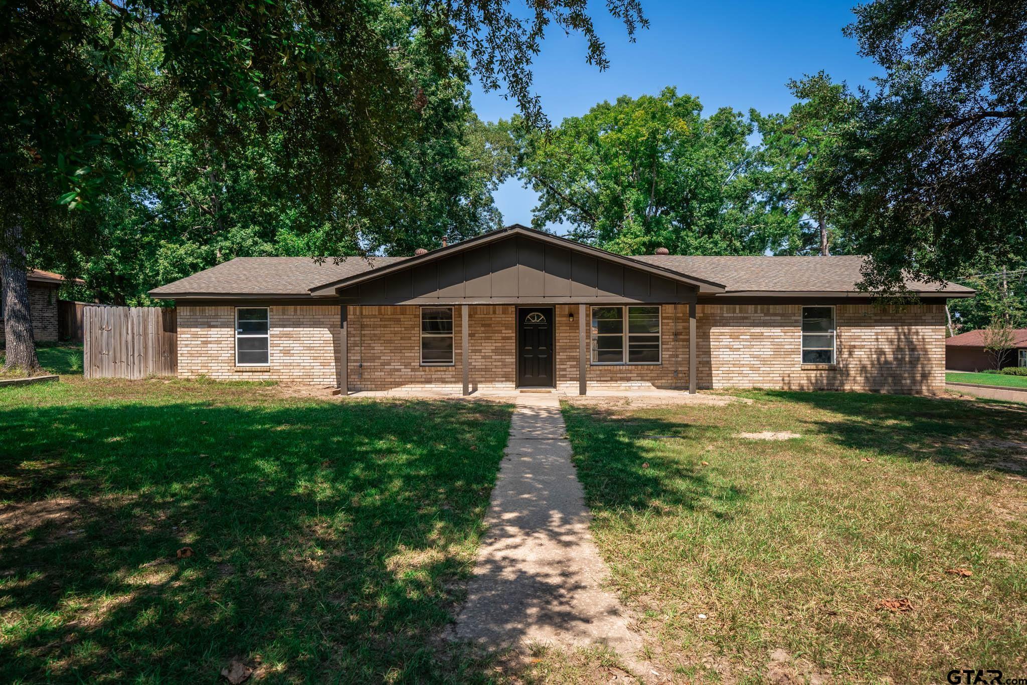 1411 Sapphire Street Longview, TX 75602 - Photo 4 of 38 a front view of a house with garden