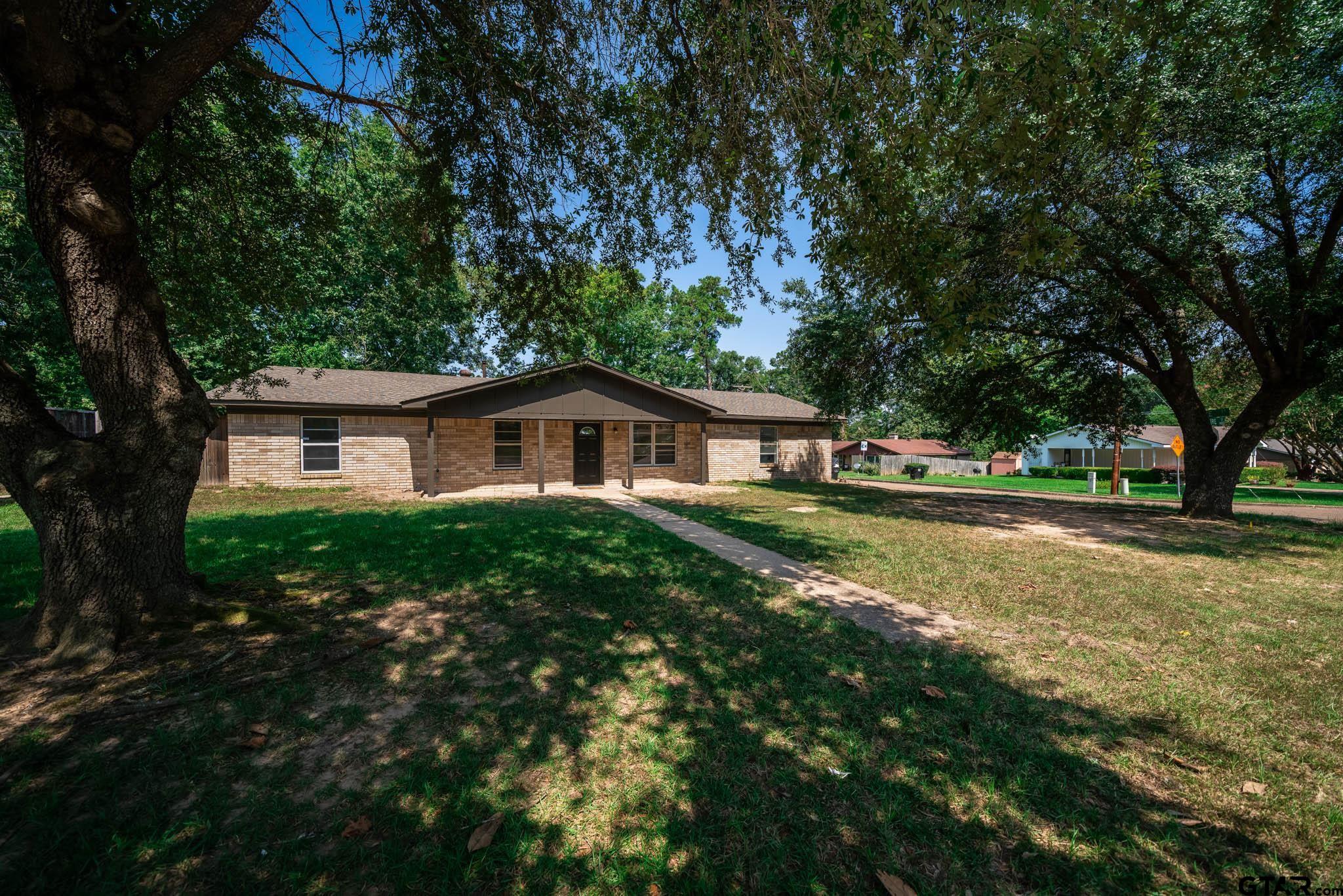 1411 Sapphire Street Longview, TX 75602 - Photo 5 of 38 a front view of house with yard and green space